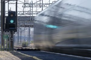 A blurred train passing a green signal