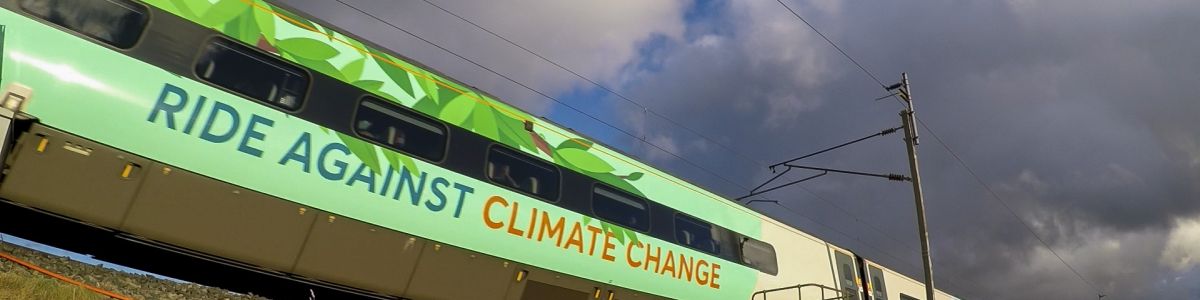 Green train with wording "Ride against climate change" on the side