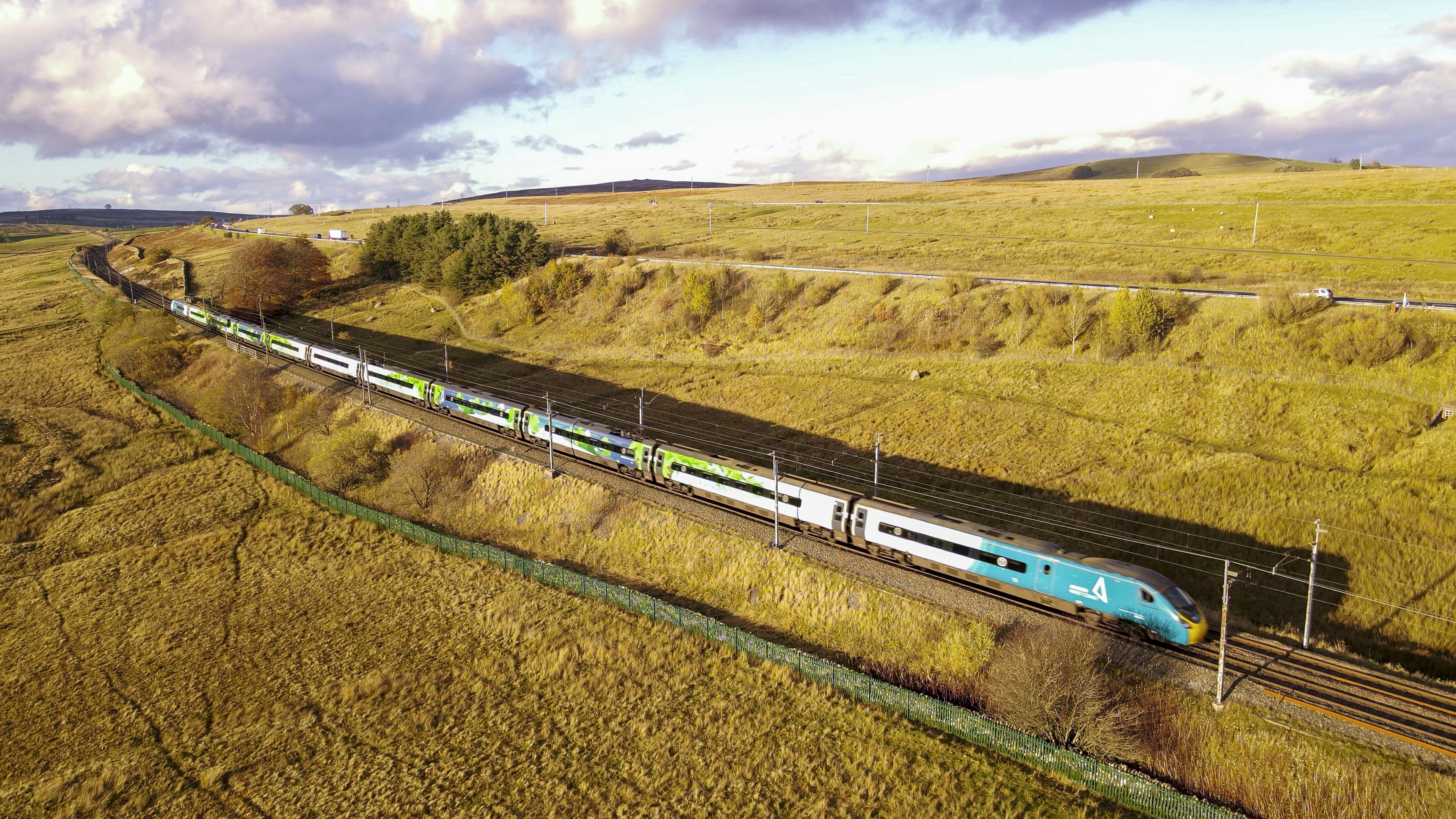 A train travelling through green countryside.
