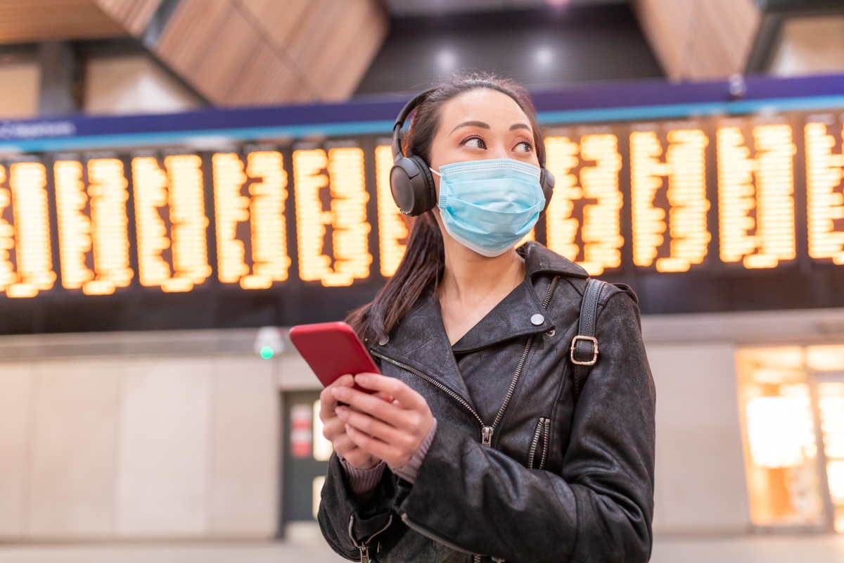 person at station with mobile phone