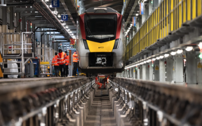 Train in depot being worked on by engineers