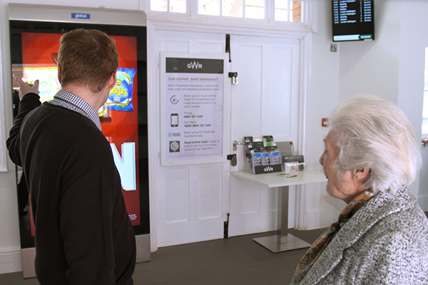 Staff member at information desk talking to customer